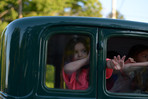 Kids waving from a Ford Model A
